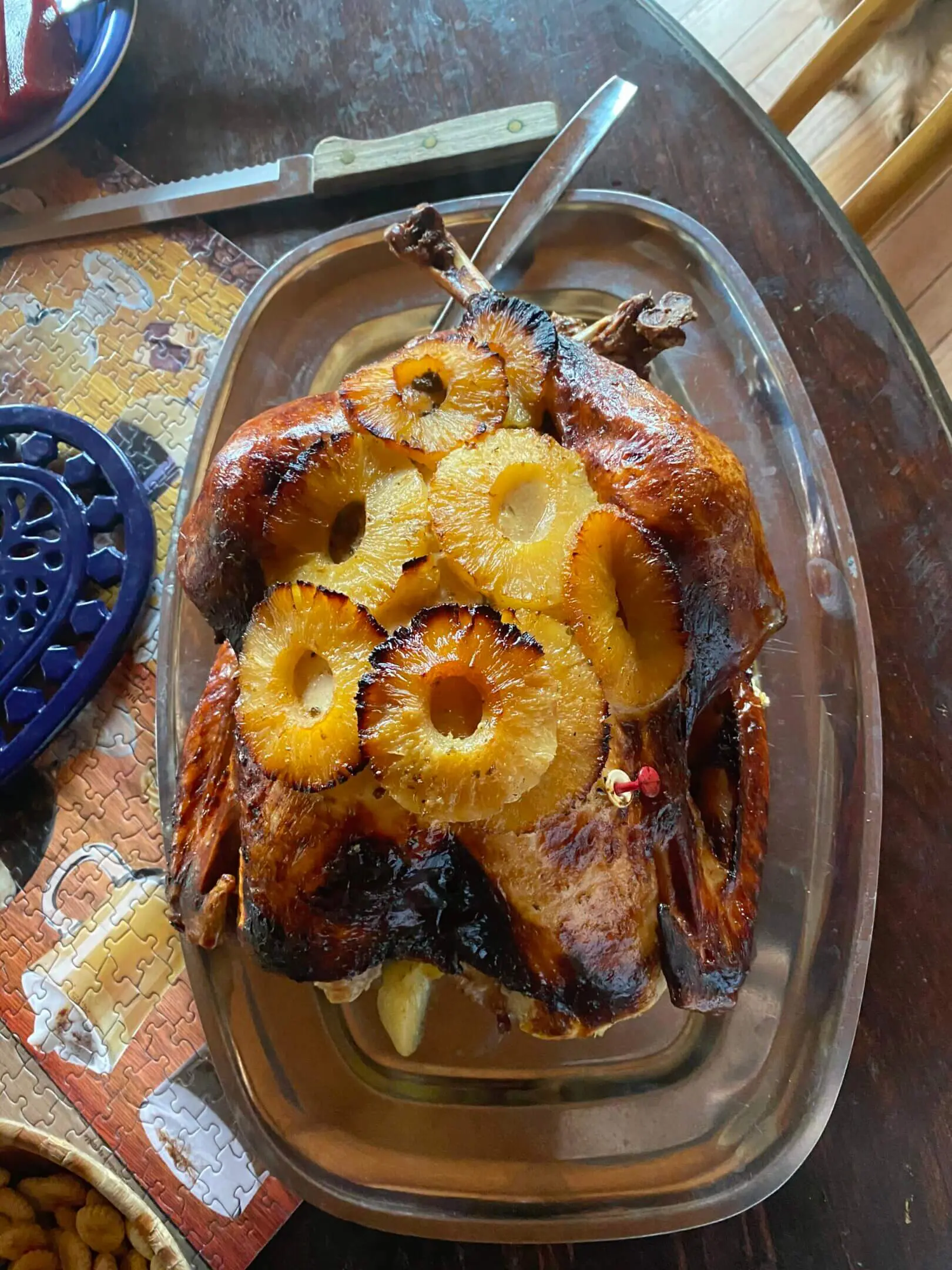 A bowl of food with pineapple on top.